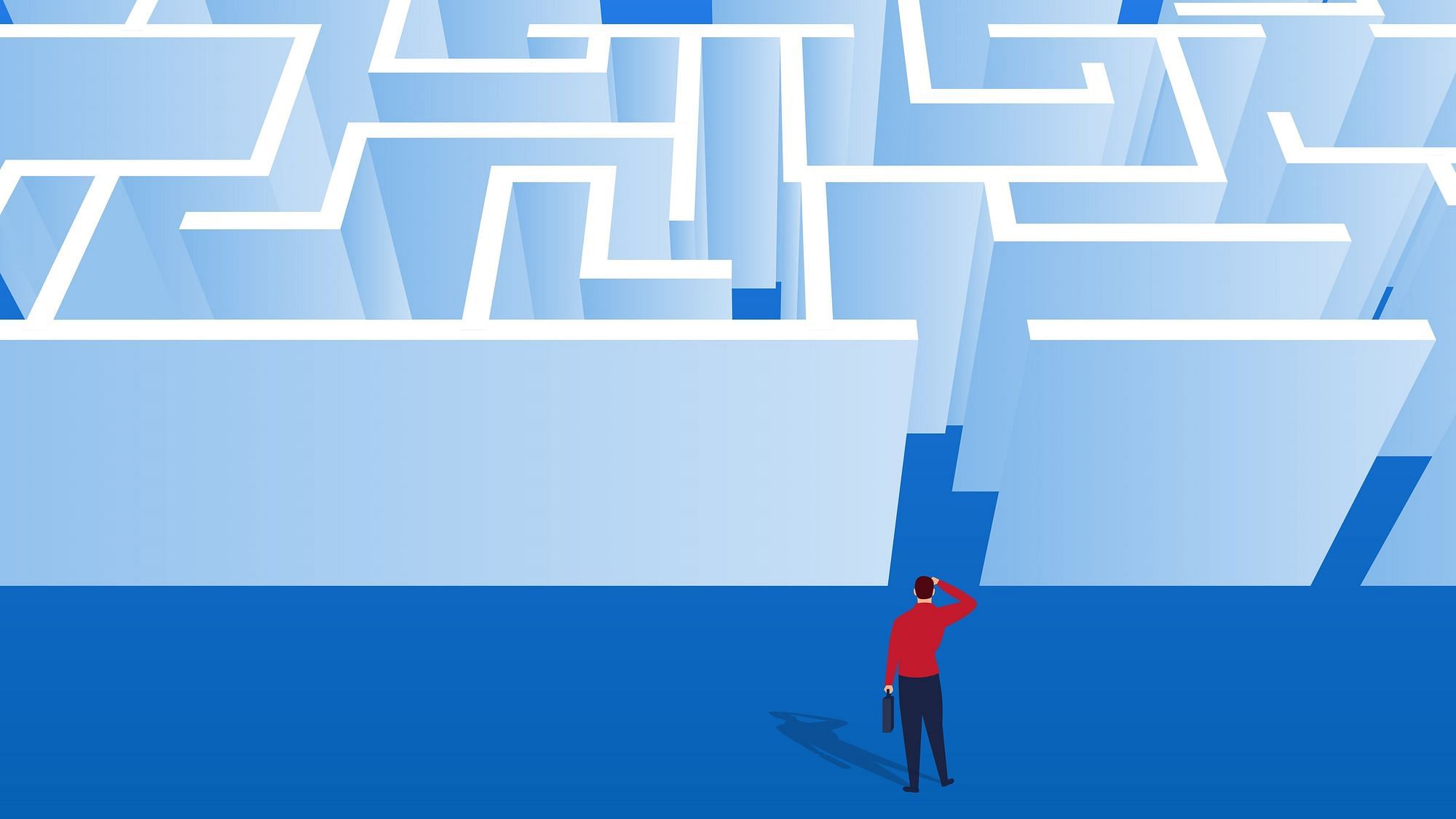 Ein Mann steht ratlos vor einem großen Labyrinth. 