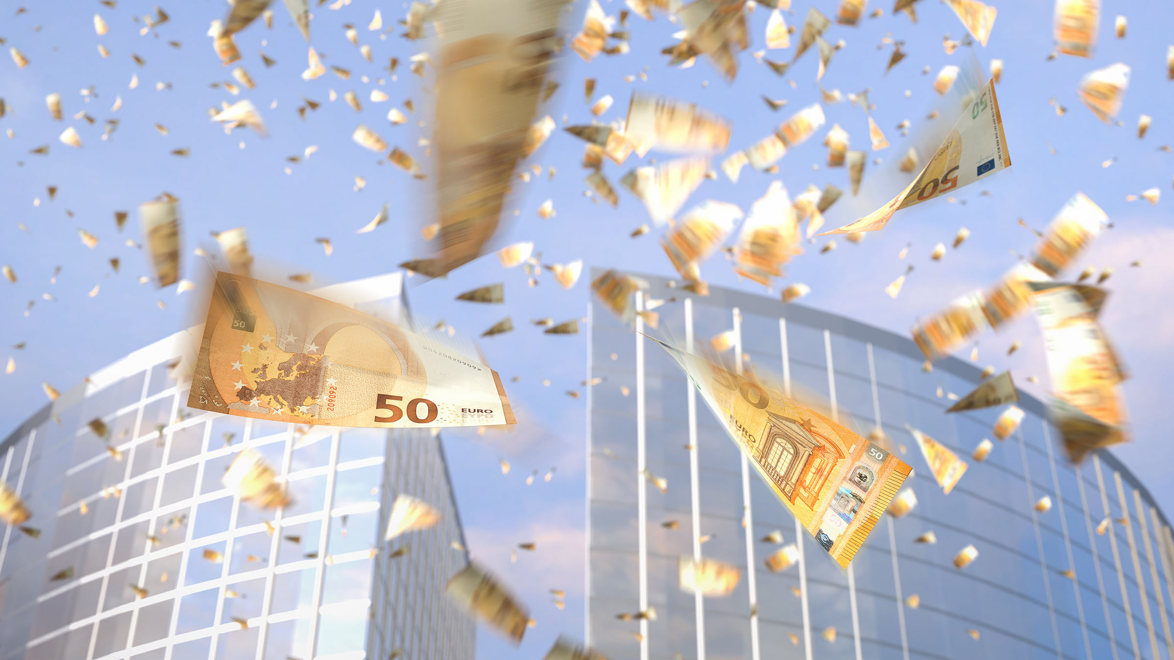 Geldscheine werden über einem Bürogebäude abgeworfen