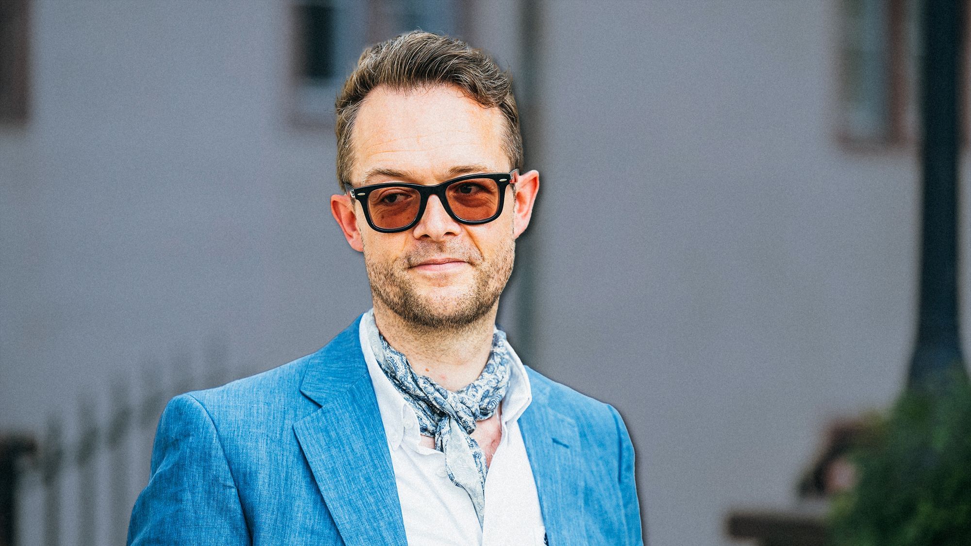 Zu sehen ist ein Mann mit getönter Brille.