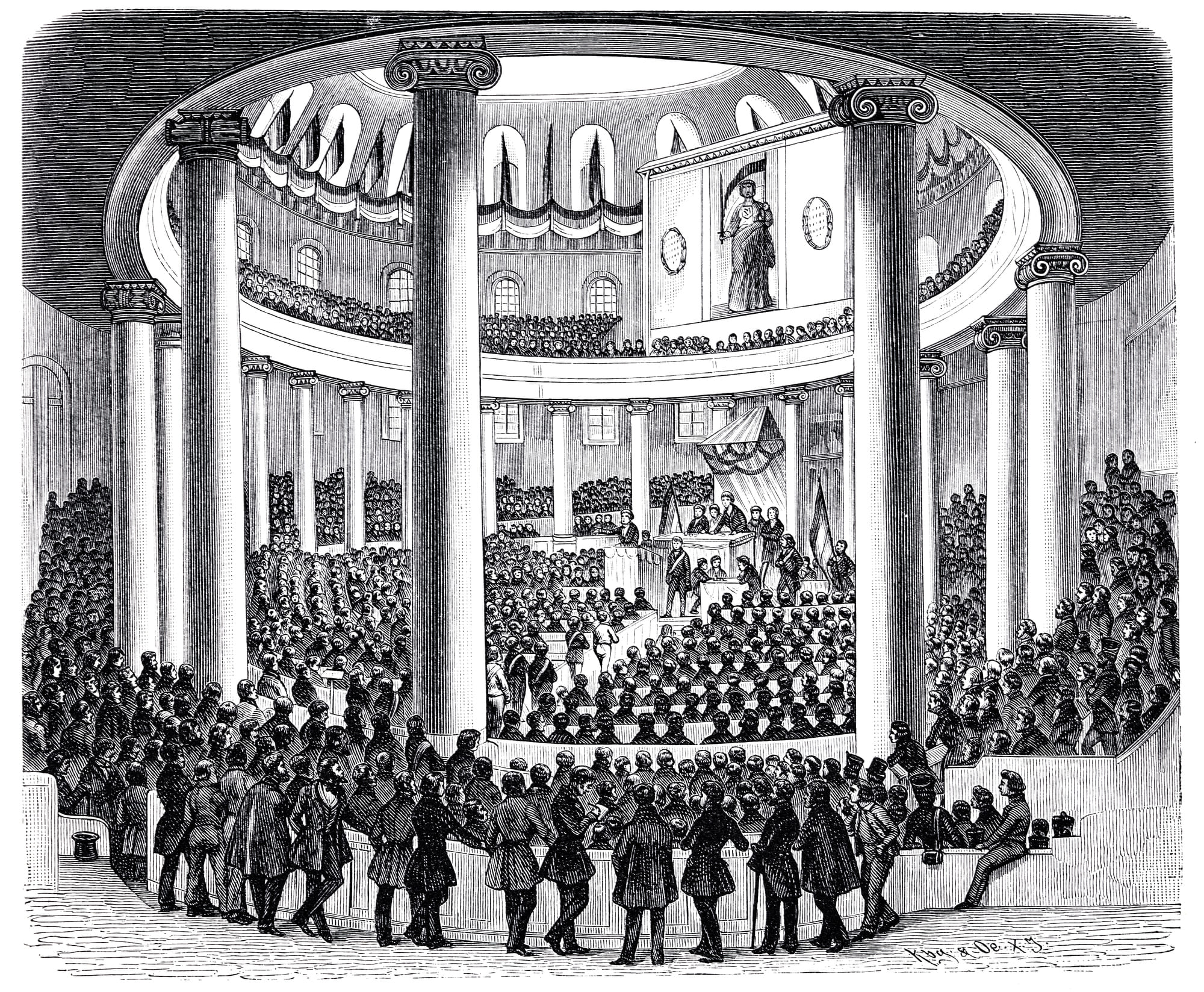 Ein schwarz weißes Bild auf dem eine Versammlung zu sehen ist, die ein Parlament darstellen soll. 