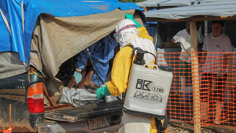 Eine Klinik in Foya, Liberia: Vermutliche Ebola-Patienten kommen an. Ein Hygieneexperte empfängt sie mit einer Chlorlösung, mit dem er sie und das Auto besprüht.