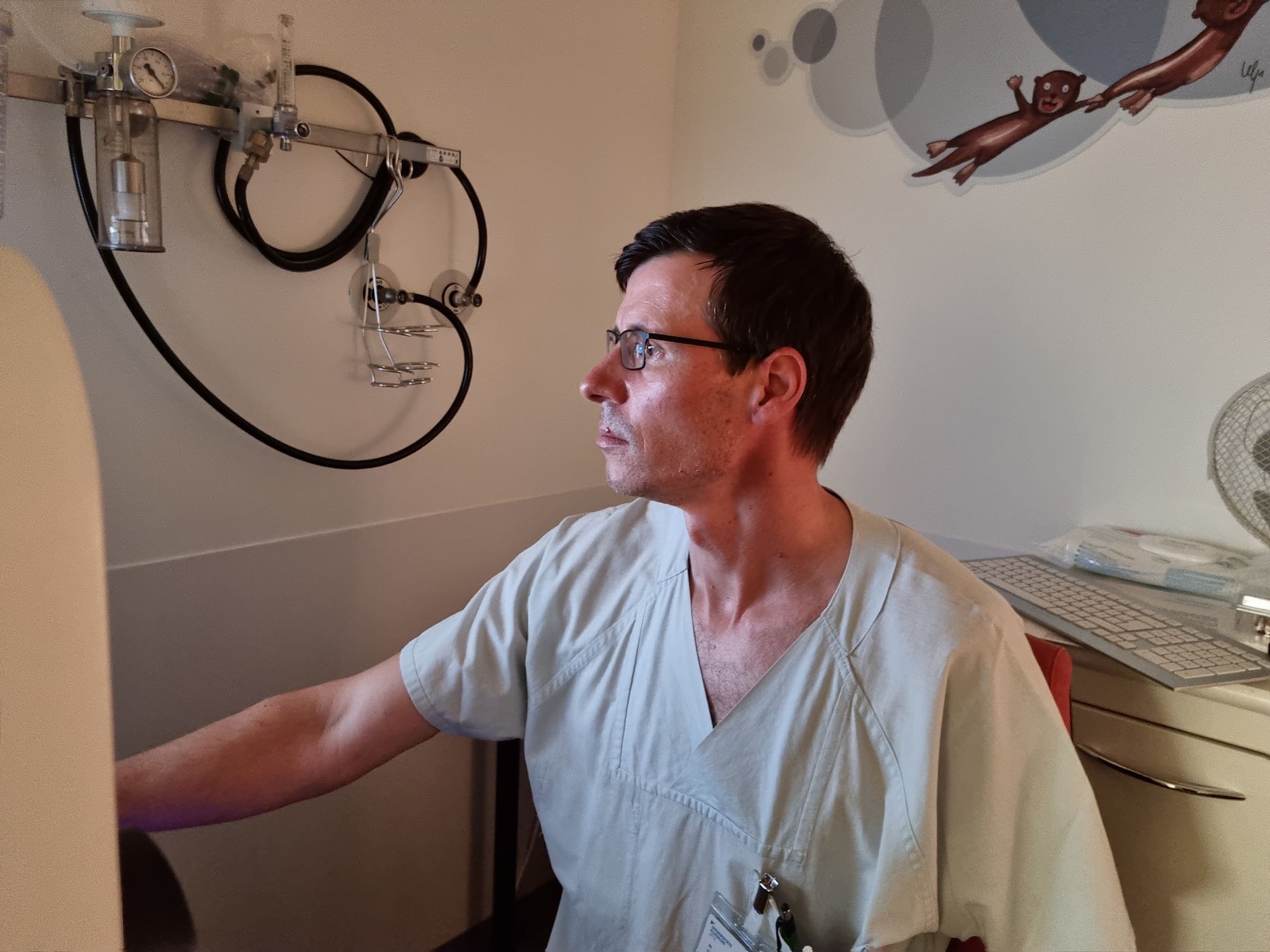 Der Arzt Daniel Vilser sitzt an einem Bildschirm in seiner Praxis.