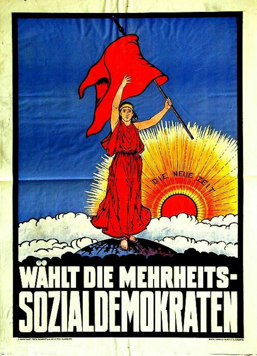 Zuversichtlich blickt die Frau mit der roten Fahne der Arbeiterbewegung in die Zukunft. Hinter ihr geht die Sonne auf - seit der Aufklärung das Symbol eines neuen, eines besseren Zeitalters, das nun beginnt. Darunter steht "Wählt die Mehrheits-Sozialdemokraten.